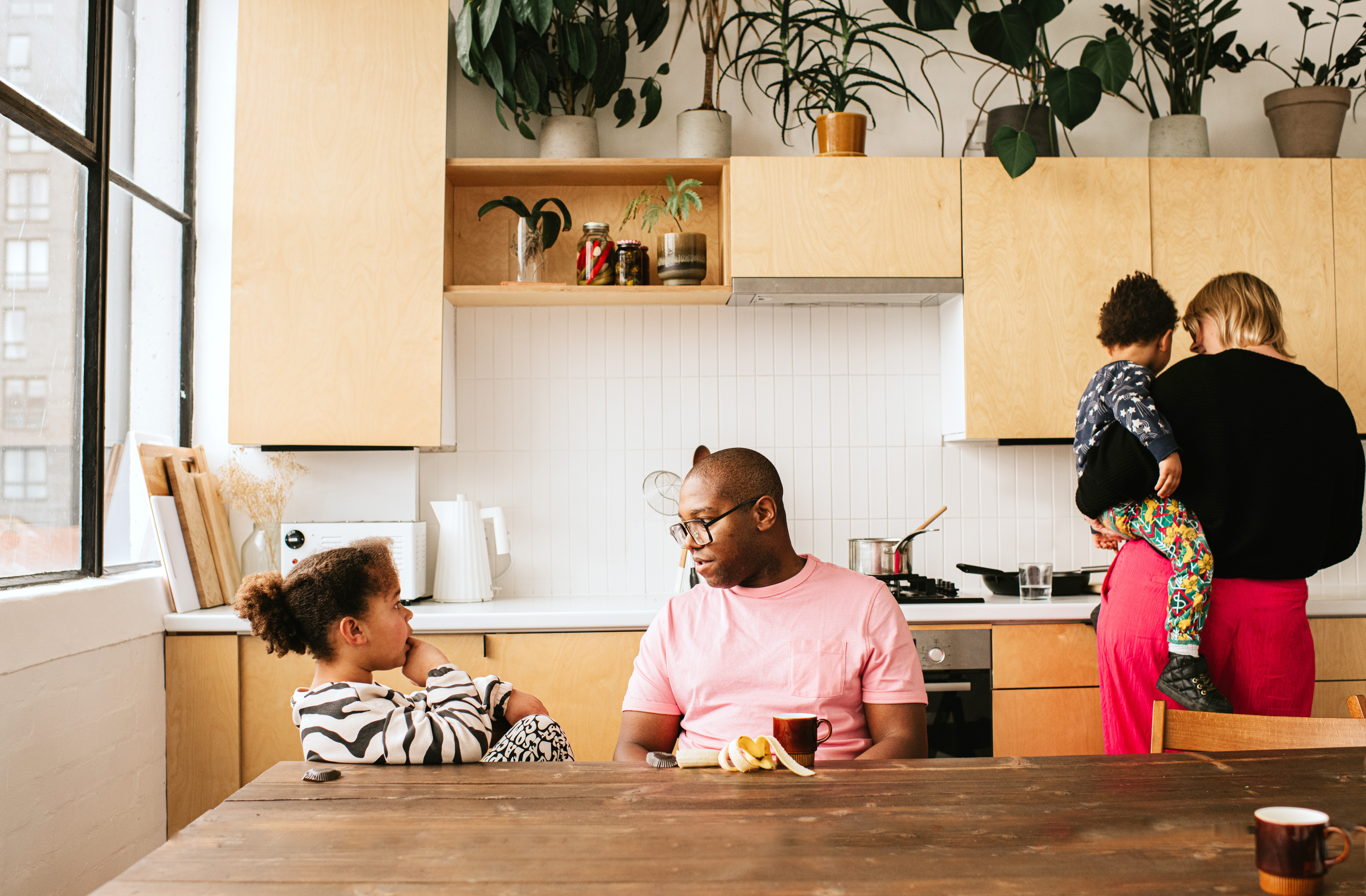 Family spending time together in a kitchen with plywood cabinets