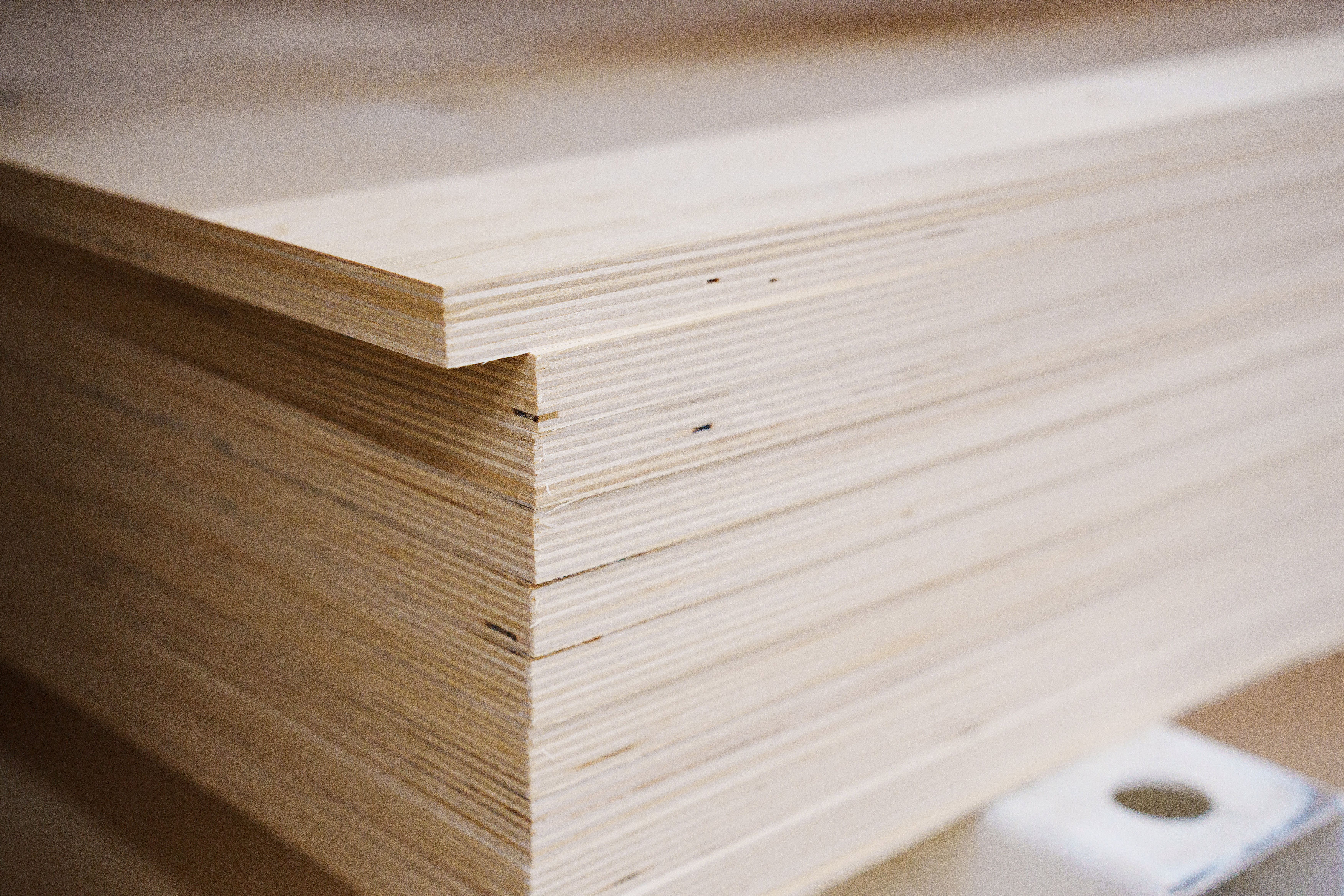 A stack of plywood sheets on a rack