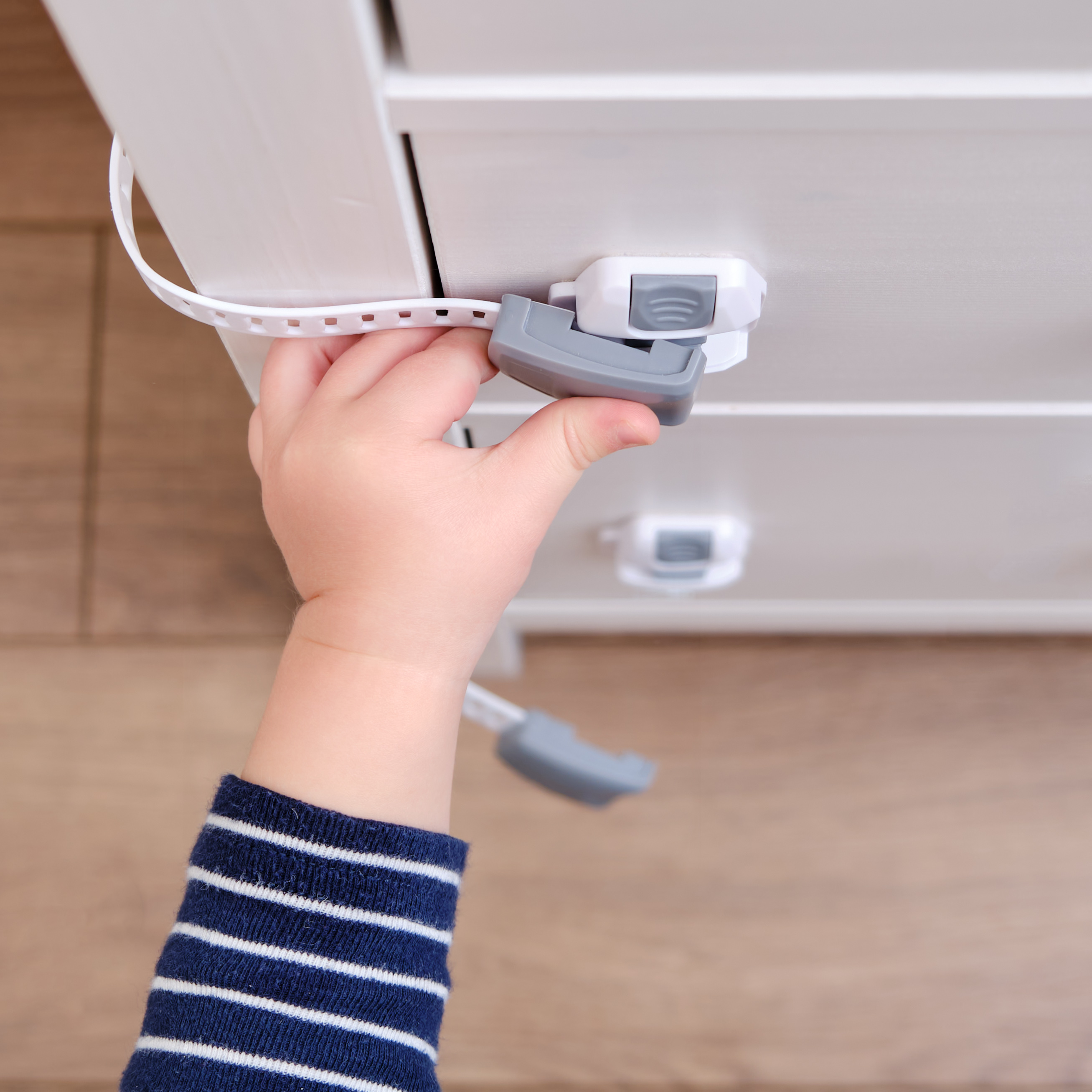 The child is locking the drawer