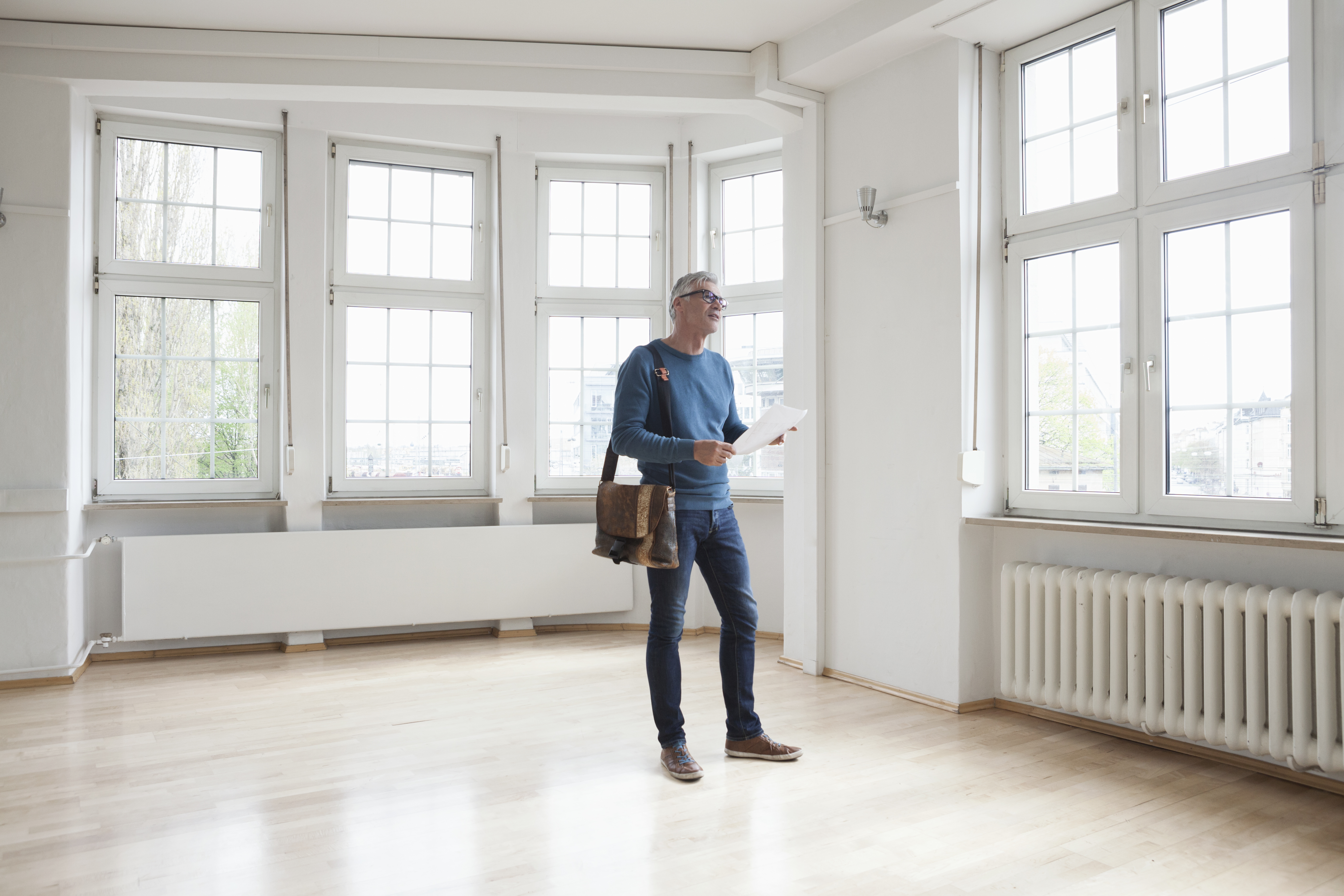 Man looking around in empty apartment 