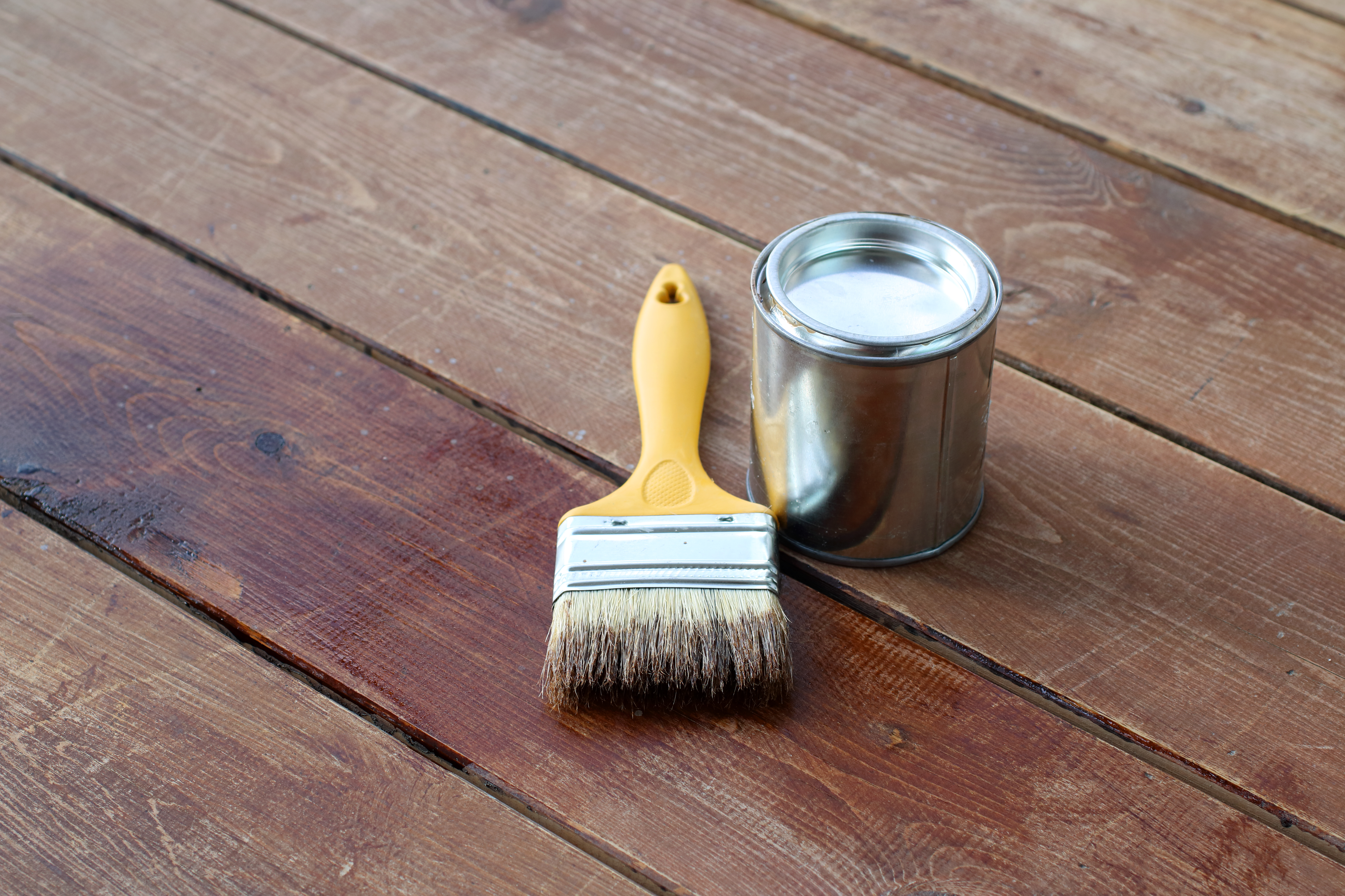 Paint brush and paint can and for a timber deck 