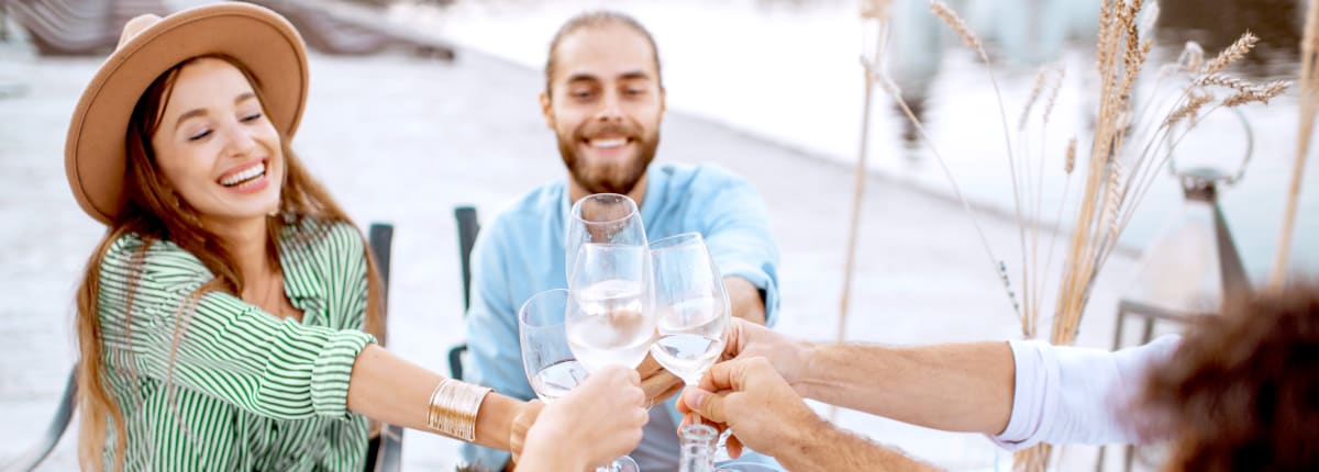 Anora - Contact us hero image - people dining by water