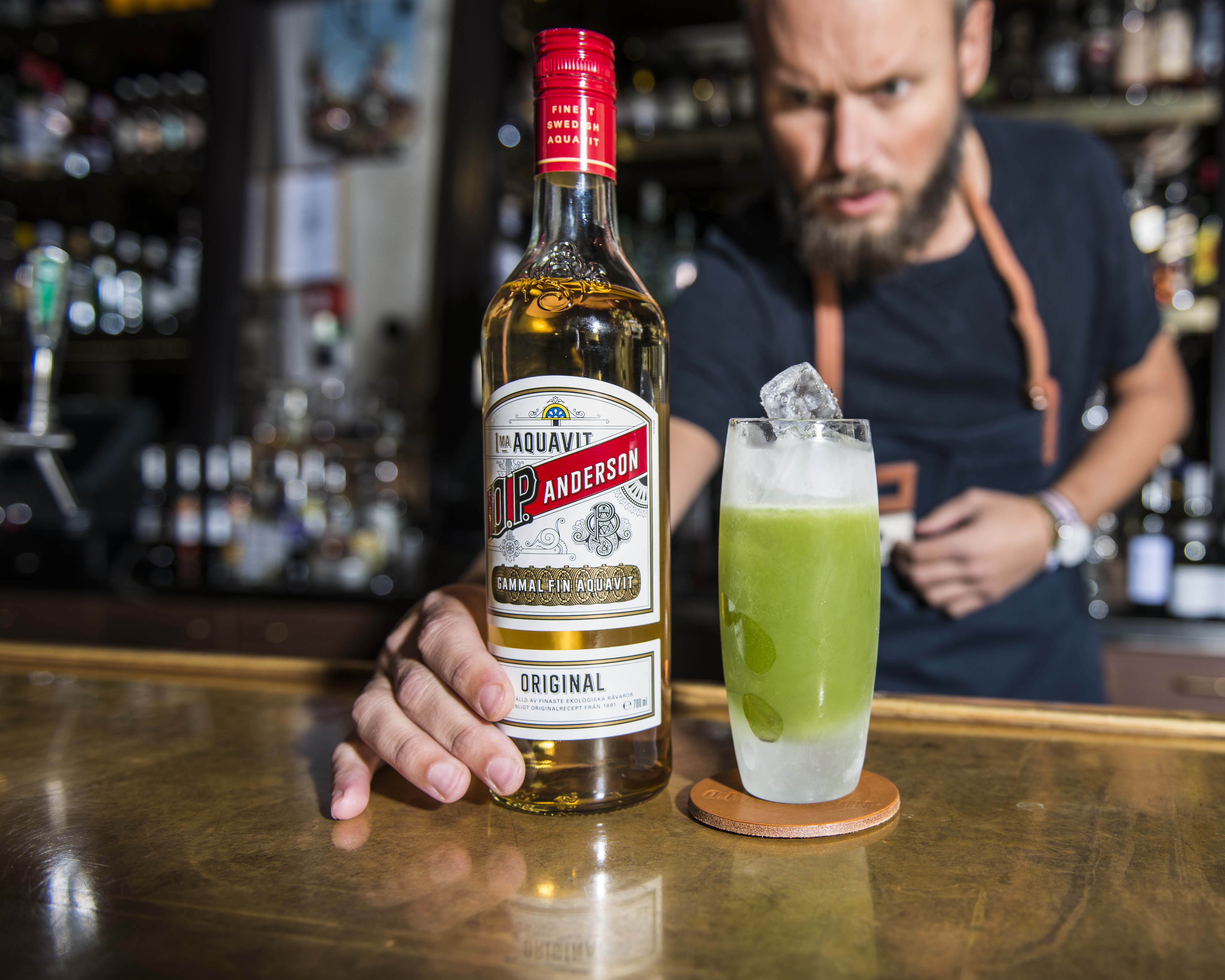 Man in bar with OP bottle and drink glass Man in bar with OP bottle and drink glass