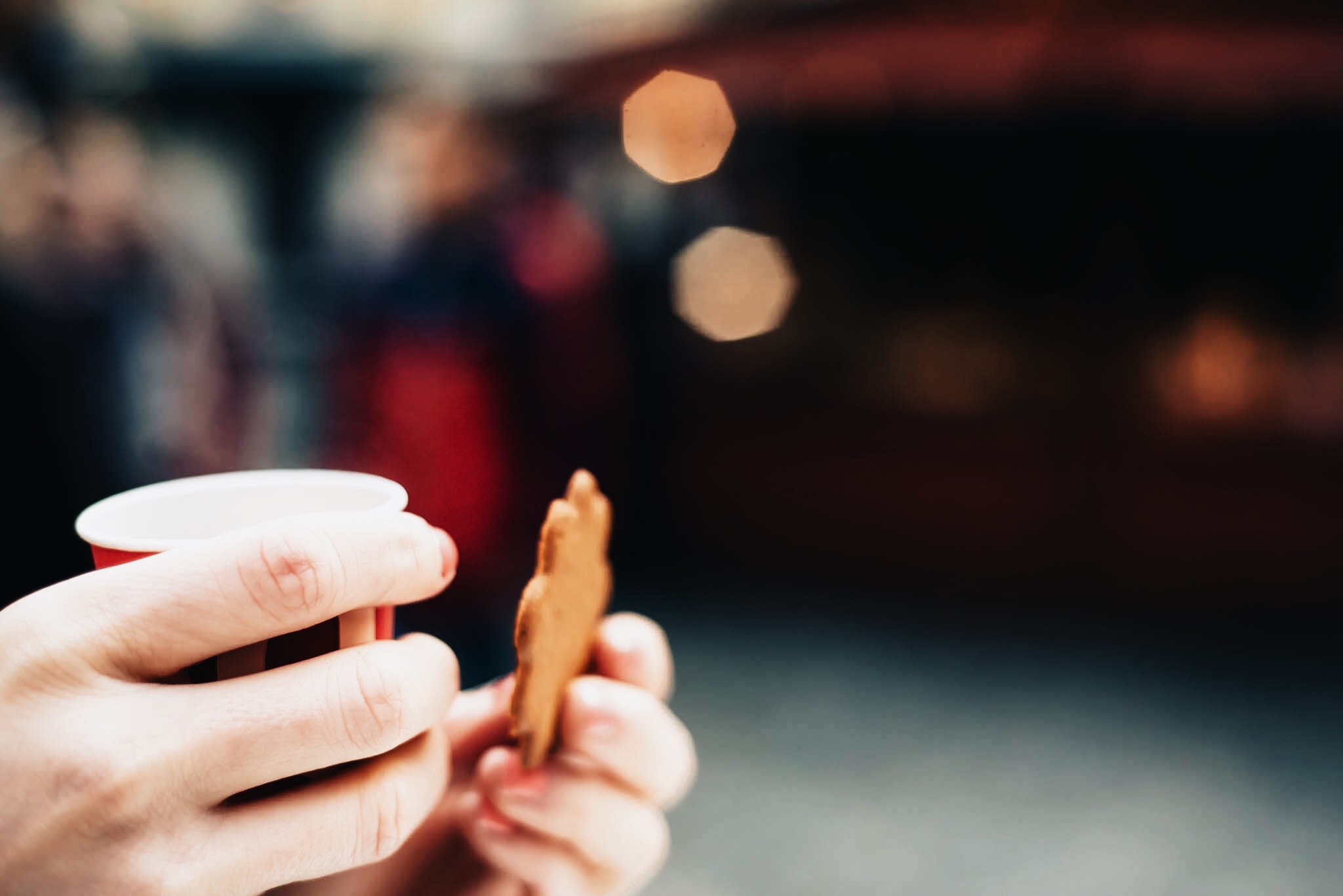 Cookie and cup in hands