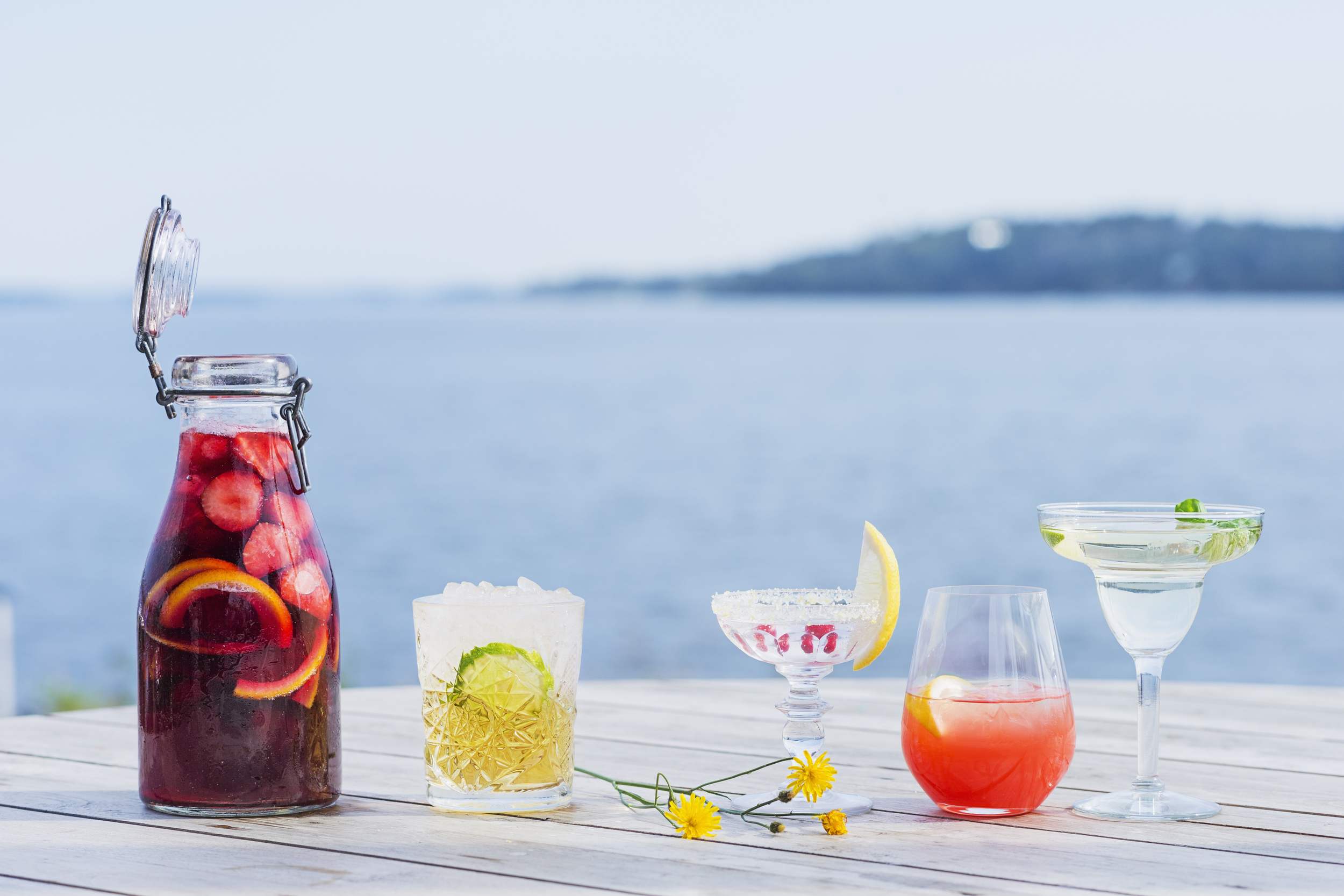Anora brand image - cocktails on a pier