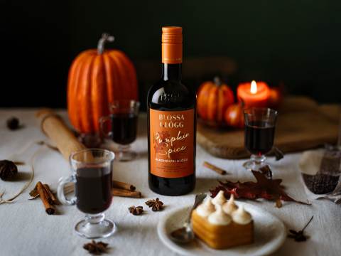 Blossa Pumpkin Spice på bord med pumpor och morotskaka.