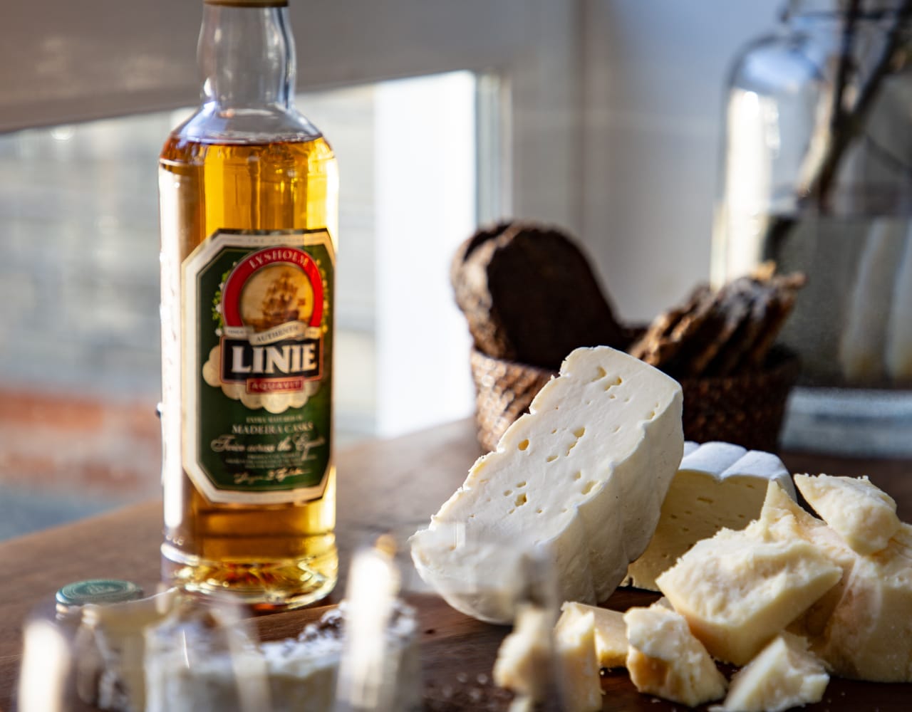 LINIE Double Cask Madeira on table with cheese selection