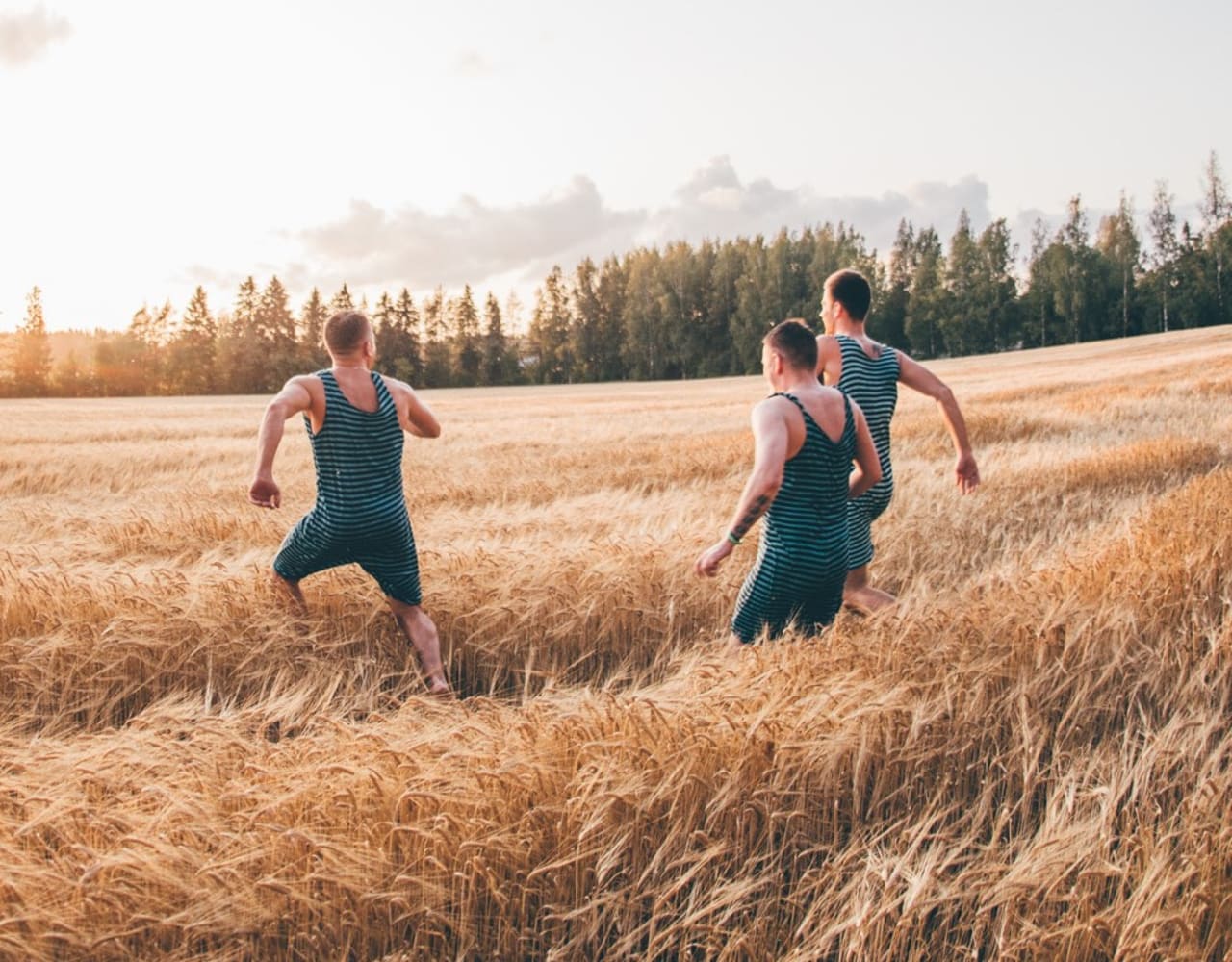 Koskenkorva people running in a barley field