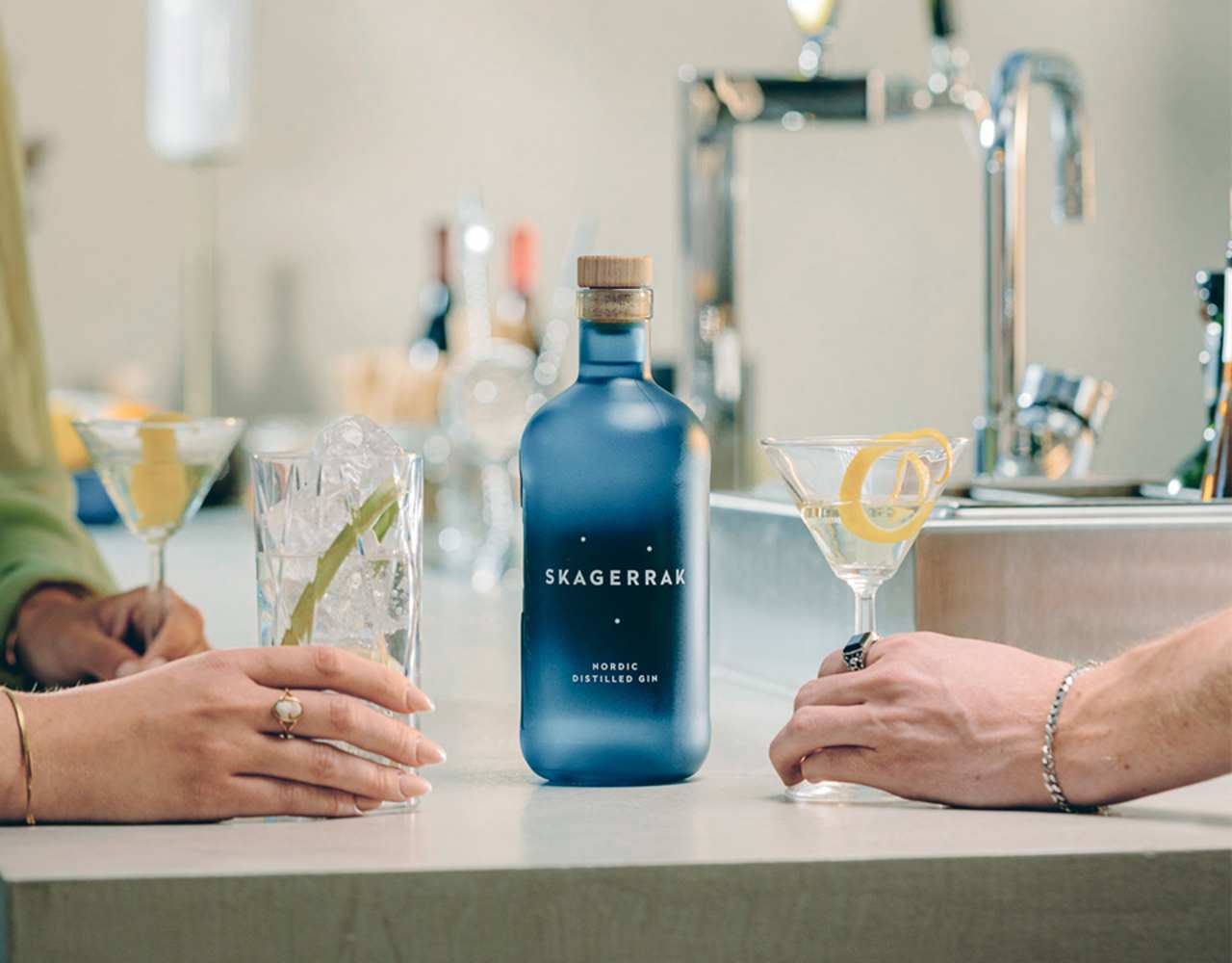 Skagerrak gin with two hands holding cocktails