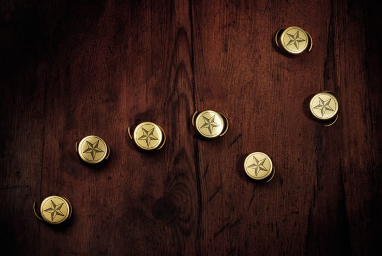 Jaloviina bottle caps on a wooden surface