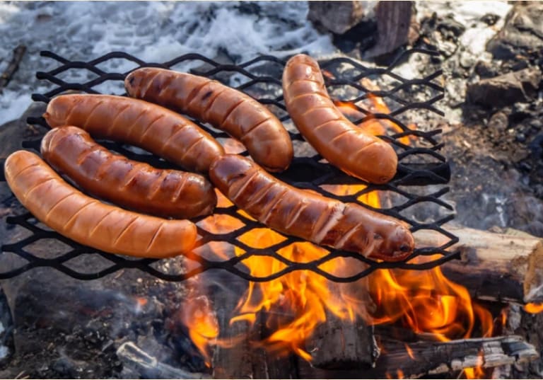 Grillimakkara sausage over an open fire