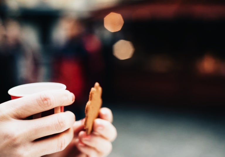 Cookie and cup in hands
