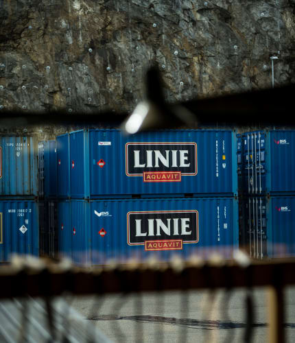 Stack of Linie Aquavit containers