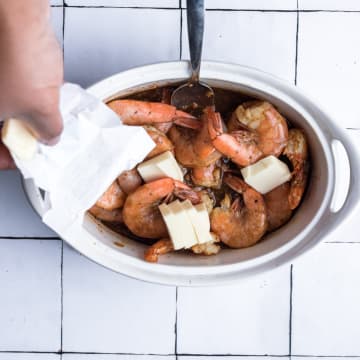 Add butter to the pan of shrimp. 