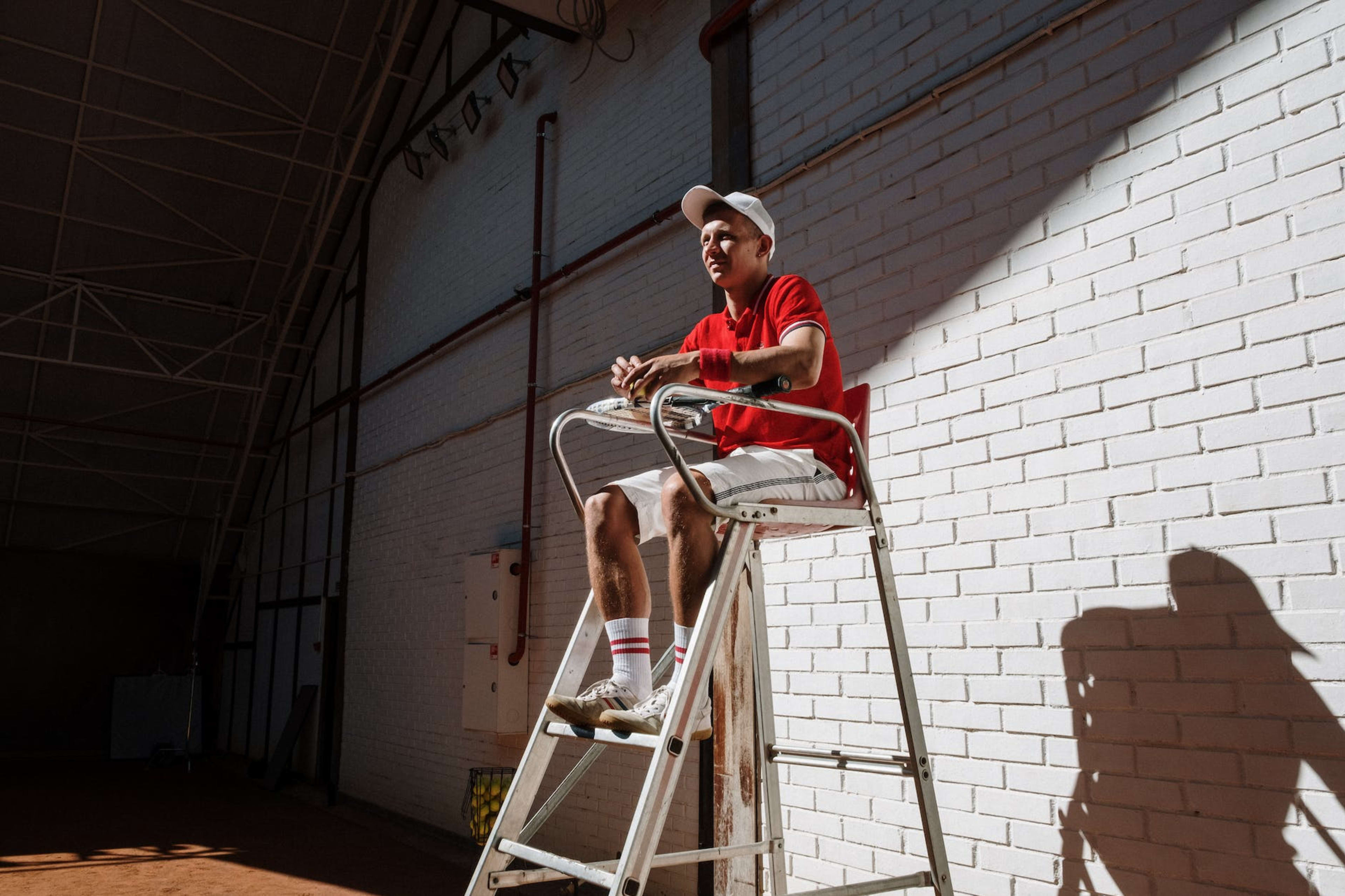 an umpire sitting on elevated chair
