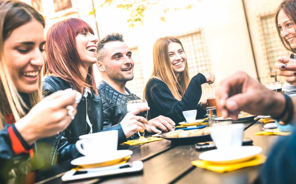 Friends drinking cappuccino at coffee restaurant - Millenial people talking and having fun together at fashion bar cafeteria