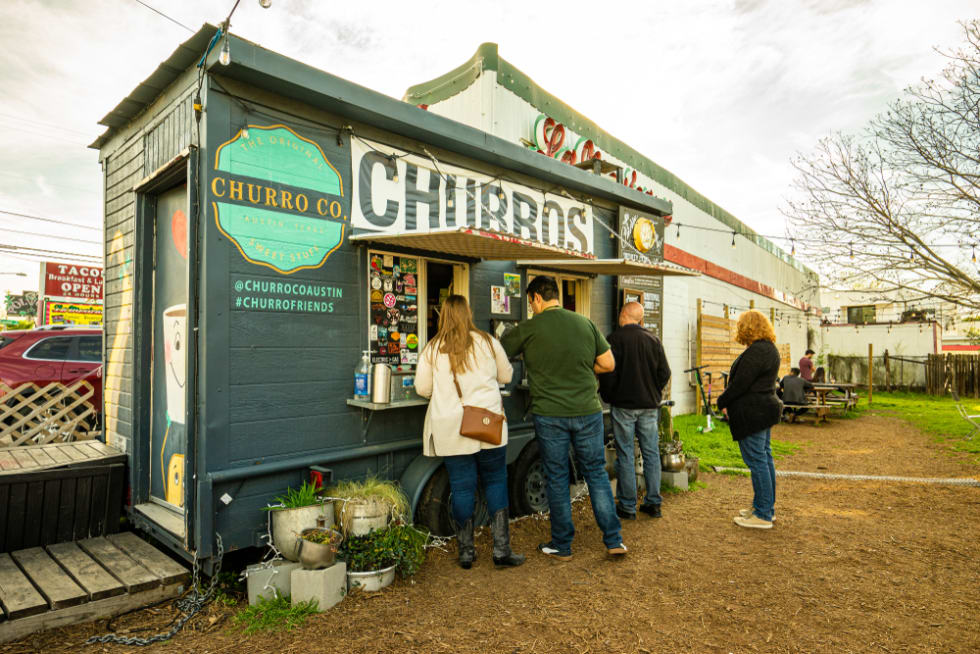  People eat at a local food truck called Austin Churro Co. in east Austin, Texas. 