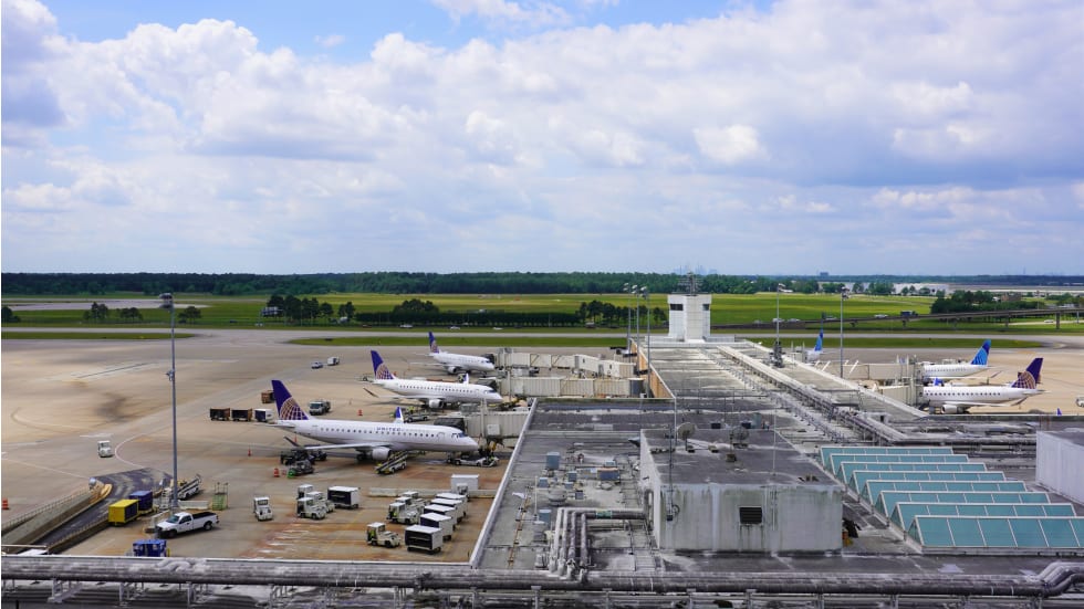 This is a picture of several aircraft, parked at their gates, waiting for passengers and flight times at Houston airport - cost of living in Houston