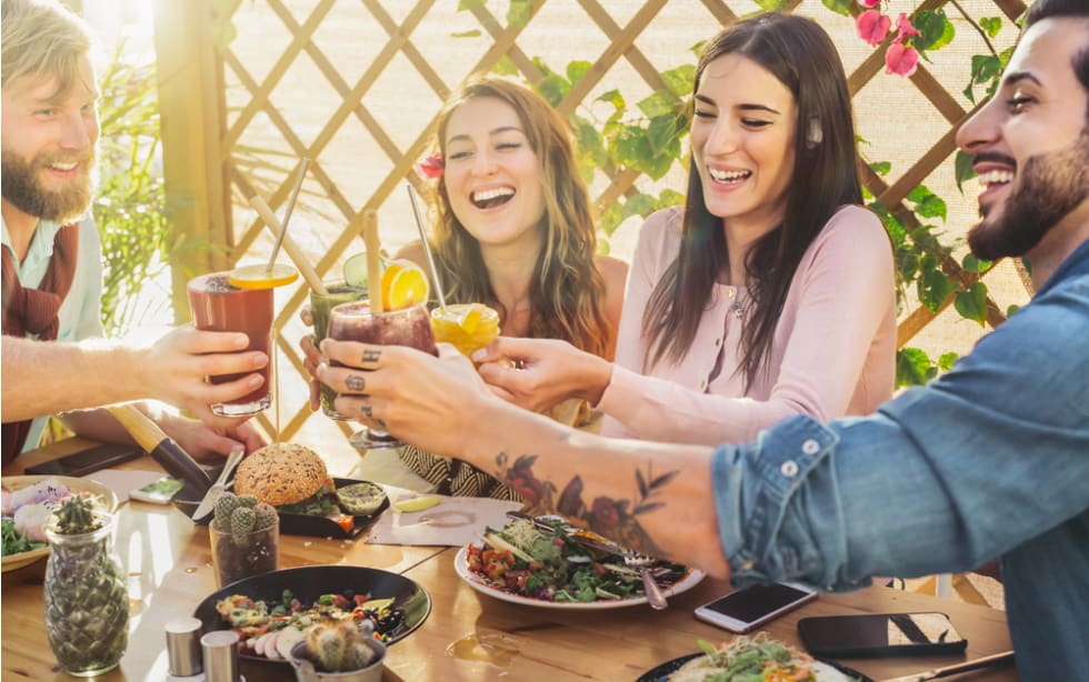 Happy friends lunching healthy food and drinking smoothies fresh fruits - Young people having fun eating in coffee brunch vintage bar - Health trends and lifestyle culture concept