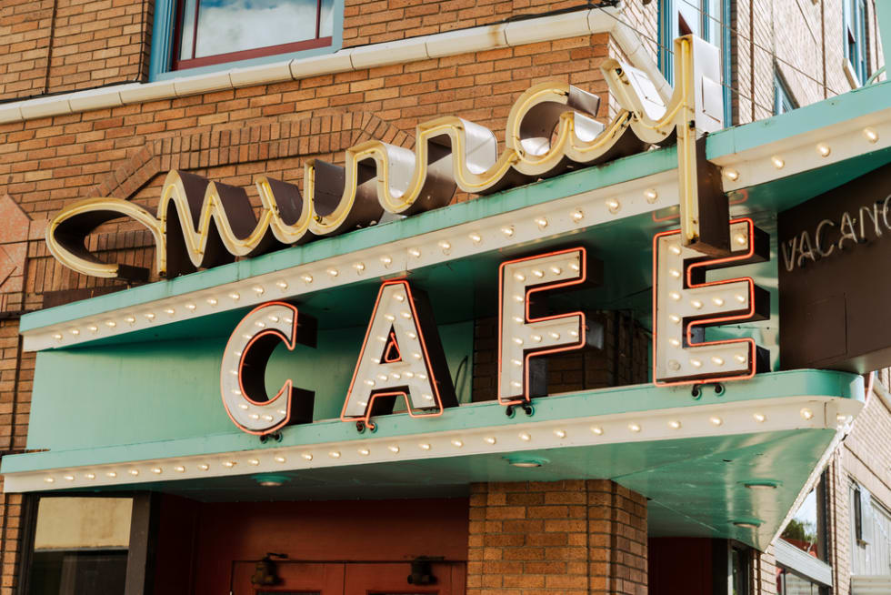The neon sign for the Murray Cafe and Hotel in the downtown area. Vintage, retro style sign