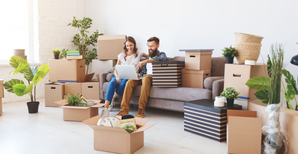 A Happy Young Married Couple Moves To New Apartment 