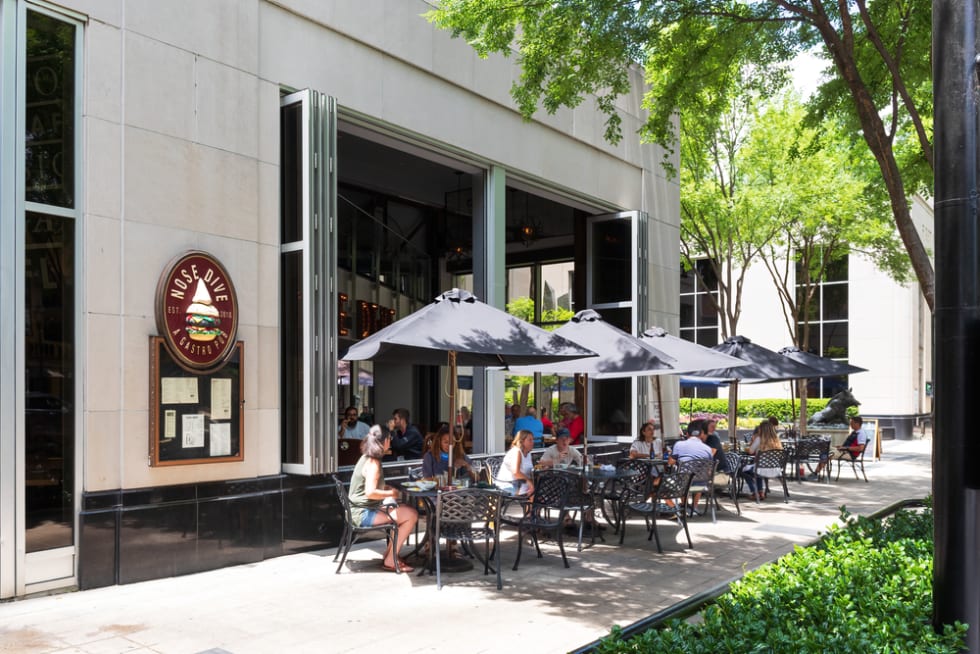 Nose Dive Pub, showing diners at sidewalk tables in Greenville