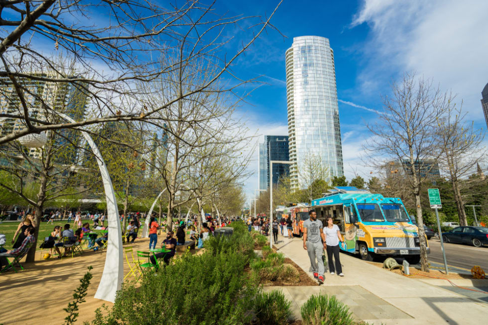 People walk around Kyde Warren Park in downtown Dallas and purchase food from food trucks