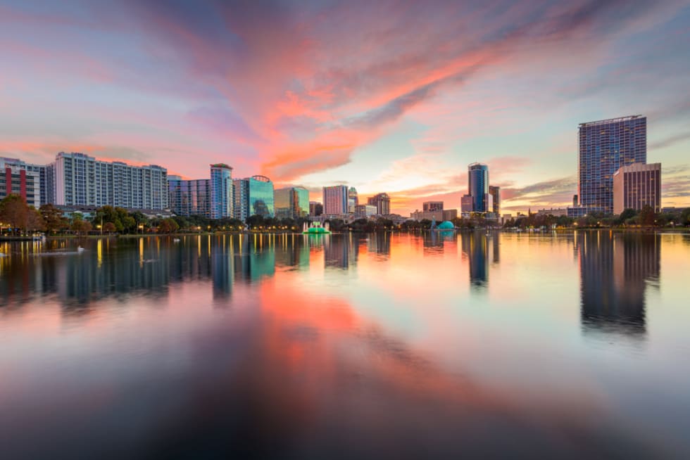 Orlando, Florida, USA downtown city skyline from Eola Park at dusk