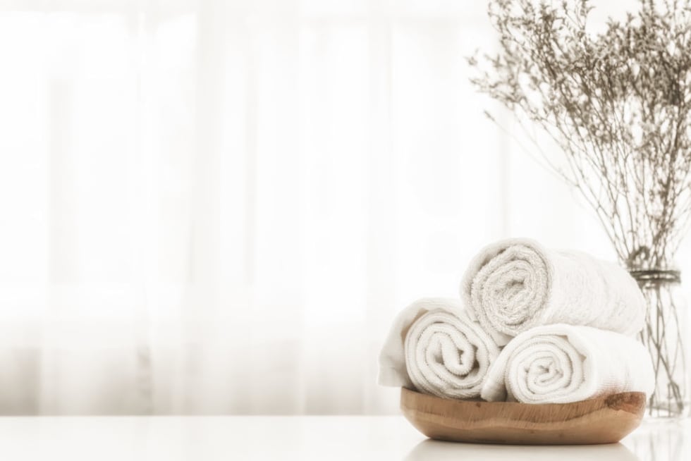 bathroom towels in wood basket