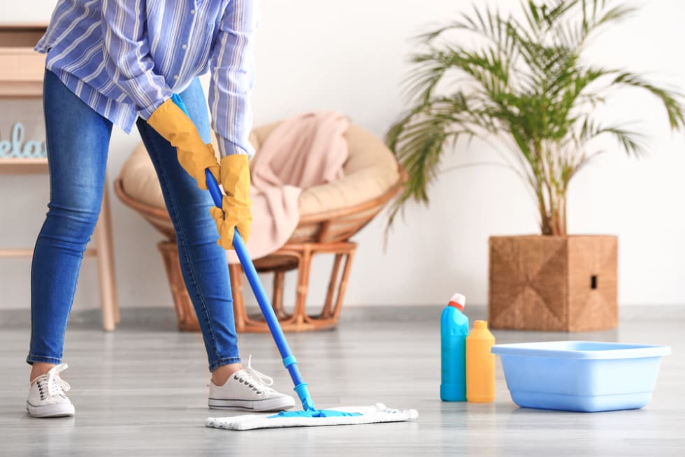 Woman mopping floor in room