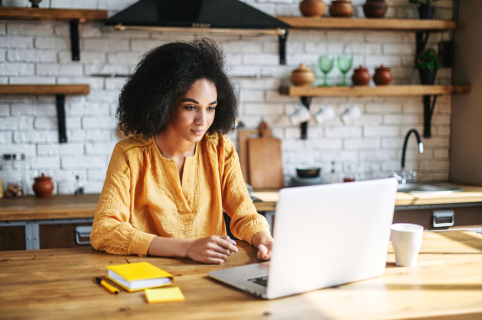 Entrepreneur young woman talking using laptop in home office