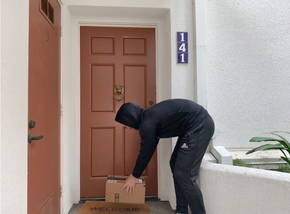 Porch pirate stealing a package