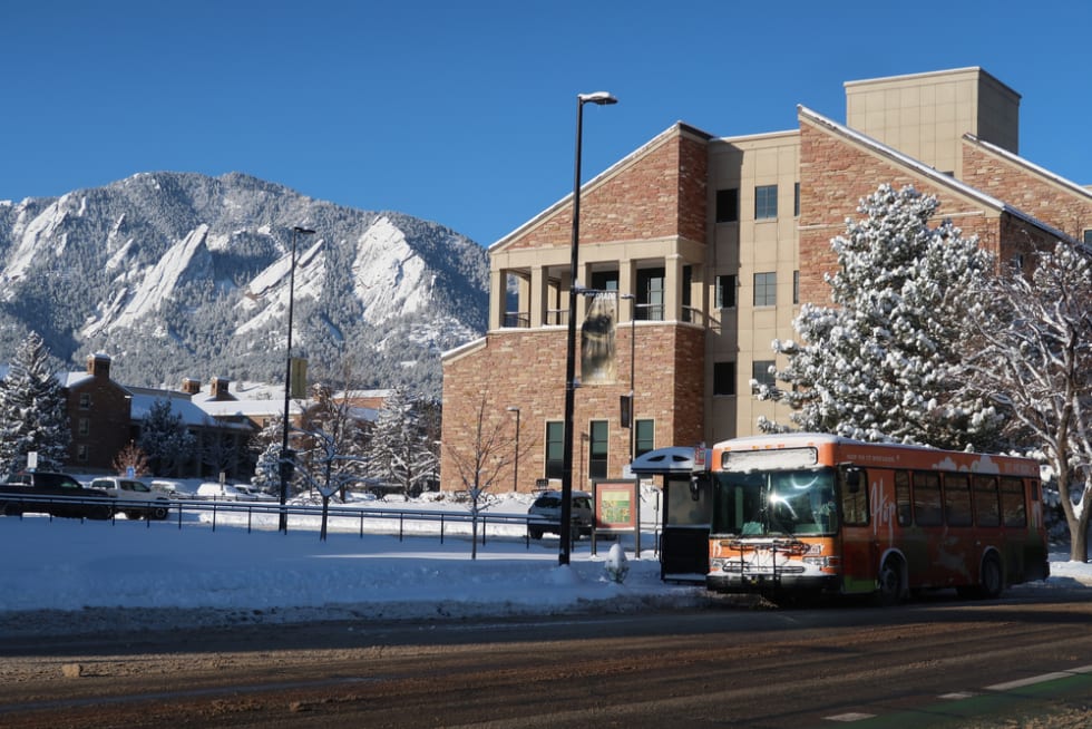 RTD Hop bus stops for riders on the University of Colorado Boulder campus on a snowy day