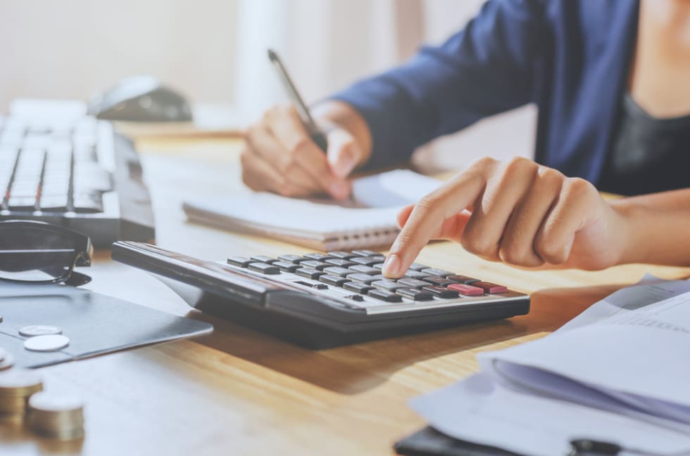 businessman using calculator on desk office business financial accounting concept