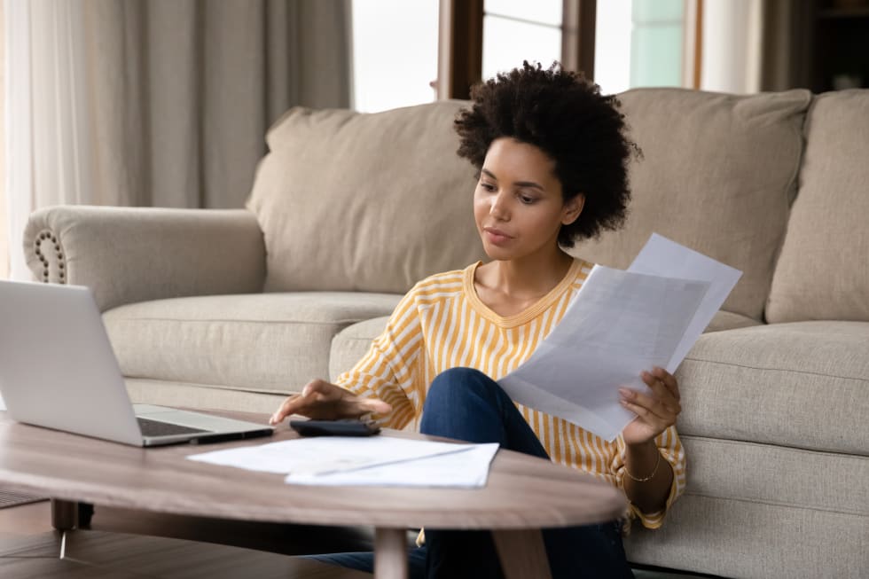 woman managing household budget, calculating domestic expenditures, planning investment, paying for utility bills taxes