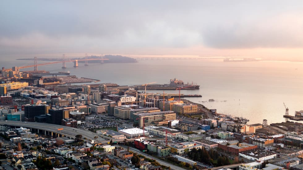  Aerial view of San Francisco's Mission Bay and Potrero Hill Neighborhoods with the bay and skyline beyond