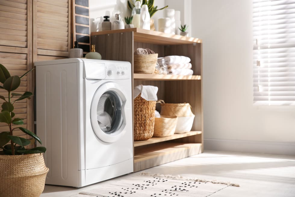 Modern washing machine and shelving unit in laundry room interiorModern washing machine and shelving unit in laundry room interior