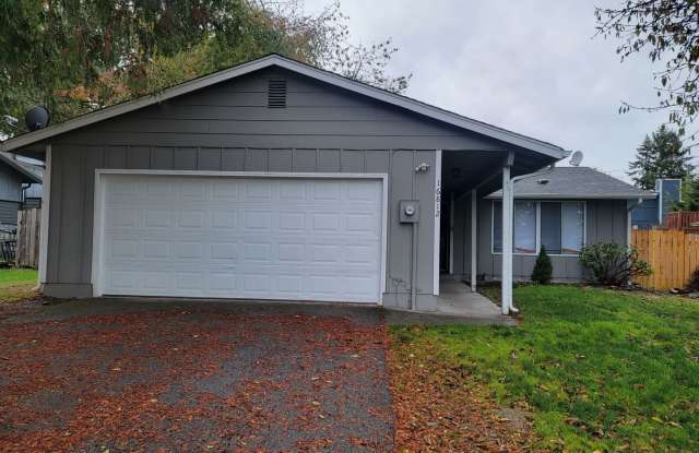 Spacious Spanaway rambler with covered patio and fenced yard.