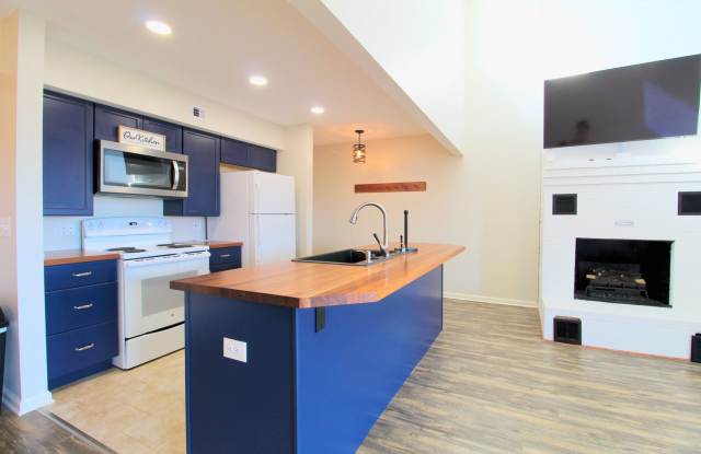 Top floor completely remodeled condo with open concept, vaulted ceilings and an electric fireplace!