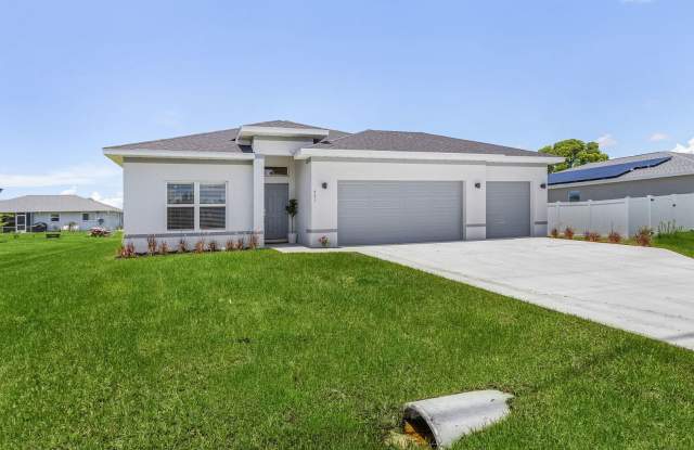 Model Home available ; Be the first to rent this BRAND NEW, 3-CAR GARAGE home. 4 bed 2 bath home - 118 Northwest 2nd Place, Cape Coral, FL 33993