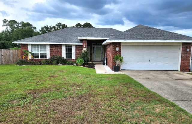 Adorably Styled and Updated 4 bedroom 2 bath Brick home located in Pace Community of La Floresta!