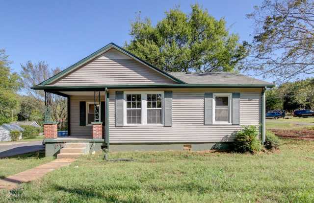 Photo of Charming Renovated Ranch Style Home With Hardwood Flooring and White Cabinetry