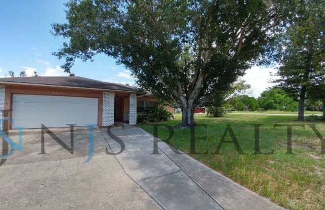 Beautifully updated 3/2/2 1500 Sq. Ft. with fenced yard, tile floors, HUGE living room and a corner lot!!