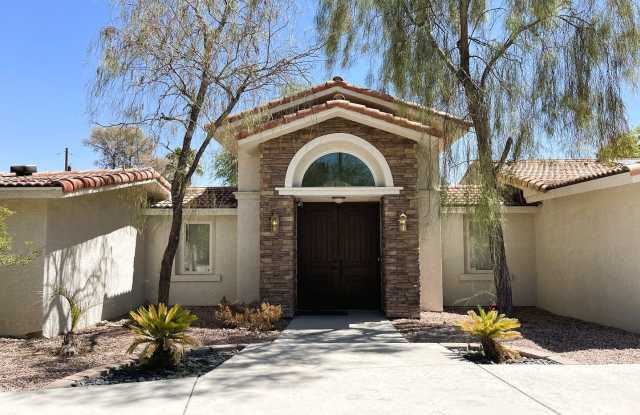 Photo of Private custom home on nearly 1.5 acres! Pool, cabana, granite bar, lush trees, courtyard, and MUCH MORE!