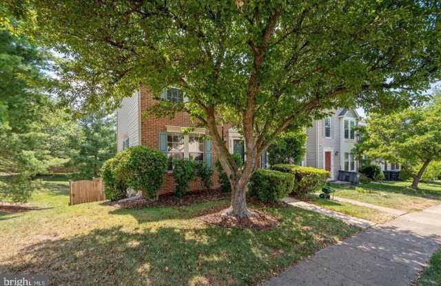 Amazing, updated end unit townhome backing to trees and open common area in Centre Ridge neighborhood!