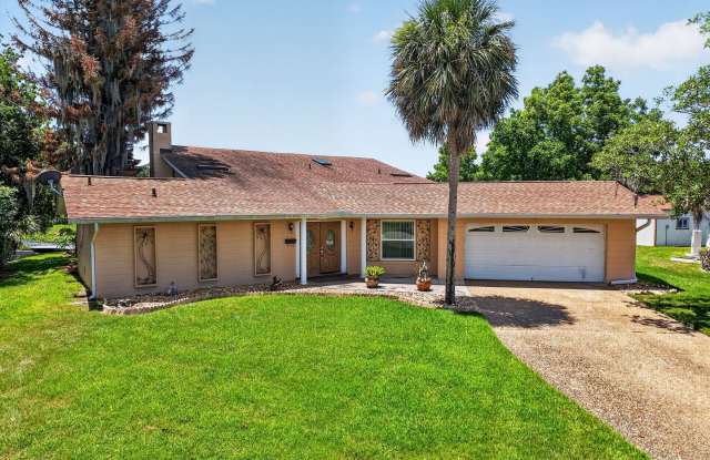 Available Now! Unique Canal-Front Pool Home with Boathouse & Chain of Lakes Access