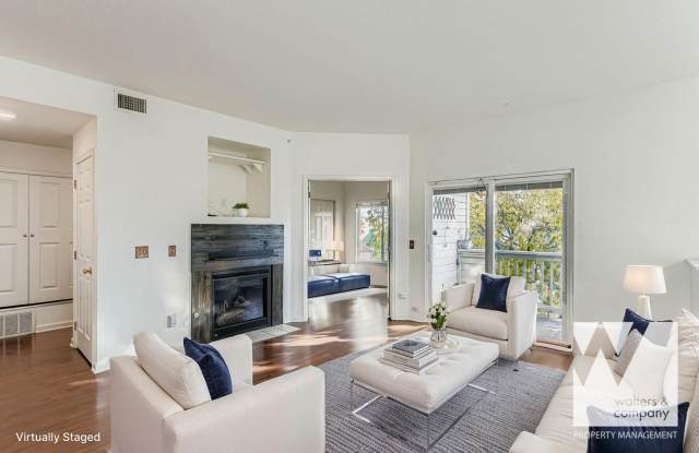 Light-Filled Corner Condo with Garage + Reserved Parking in Gated Community