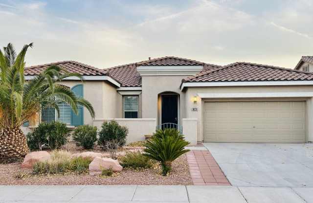 Unique single story home on a corner lot in Summerlin! Featuring natural stone tile flooring, plantation window shutters, granite countertops, and elegant crown moldings!