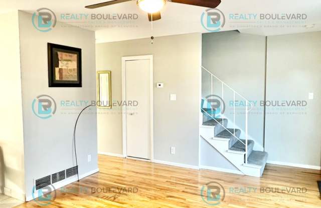 Photo of 2-bed, 2-bath, 2-story townhome with pool and park like setting outside the front door.