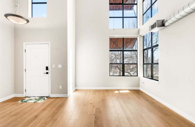 Modern 2BD, 1.5BA Condo with 20' Ceilings and Garage Parking Spot